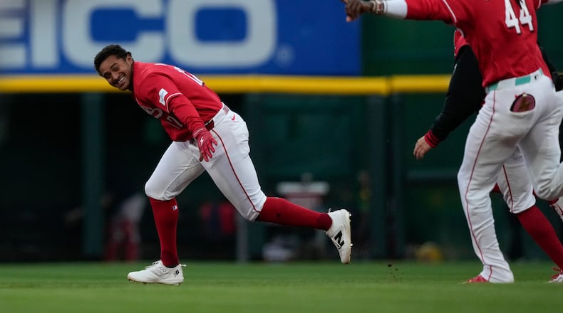 Cincinnati Reds' Dane Myers, left, celebrates with Elly de la Cruz after hitting a single to score winning run in the eleventh inning of a baseball game against the Boston Red Sox in Cincinnati, Saturday, March 28, 2026. (AP Photo/Carolyn Kaster)