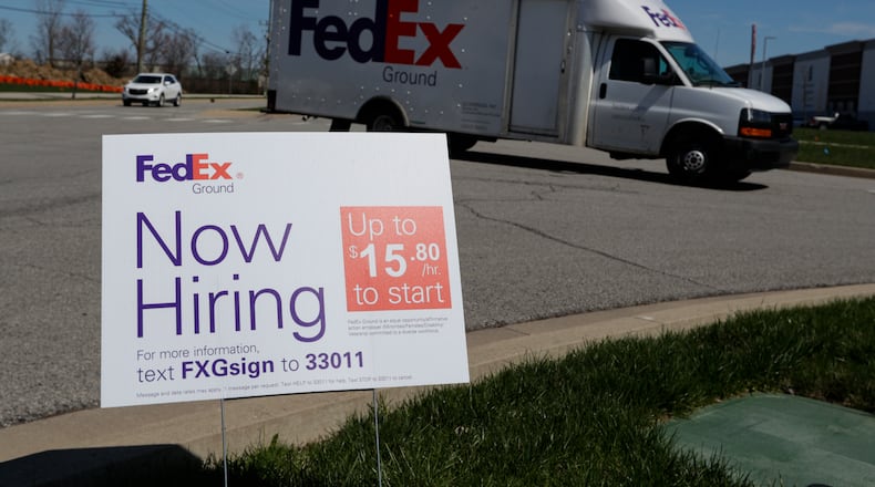 A sign advertising for jobs sits along the roadside outside a FedEx location in Zionsville, Ind. on April 2. (AP Photo/Michael Conroy)