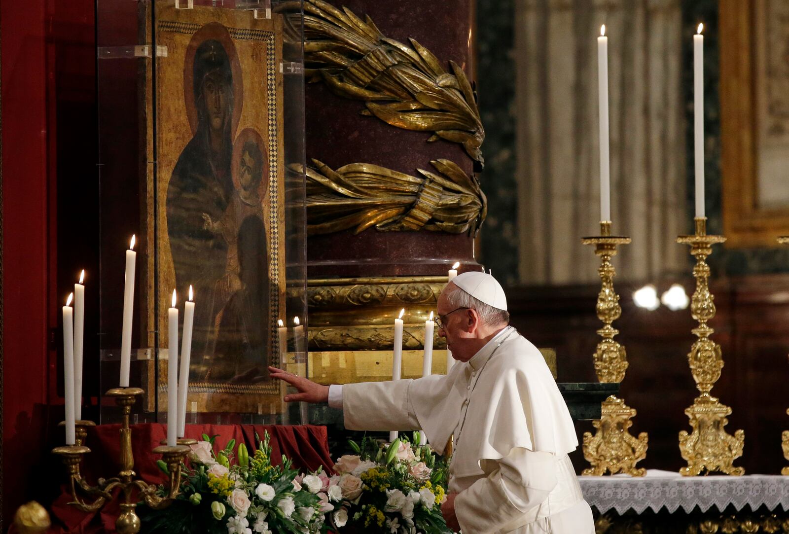 FILE - Pope Francis touches an icon of the Virgin Mary after he recited the holy rosary at the St. Mary Major Basilica, in Rome, Saturday, May 4, 2013. (AP Photo/Gregorio Borgia, file)