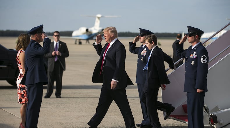 President Donald Trump and his son Barron disembark Air Force One as family of the president return from an Easter weekend in Palm Beach, at Joint Base Andrews, Md., April 16, 2017. (Al Drago/The New York Times)