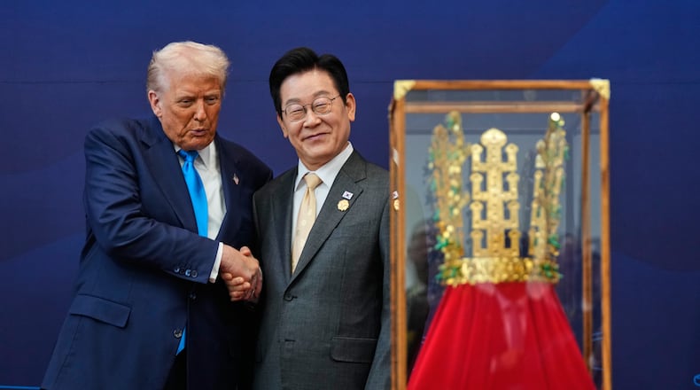 President Donald Trump shakes hands with South Korean President Lee Jae Myung as he receives a gift of a gold crown and an award of the Grand Order of Mugunghwa, not seen, during a high honor ceremony at the Gyeongju National Museum in Gyeongju, South Korea, Wednesday, Oct. 29, 2025. (AP Photo/Mark Schiefelbein)