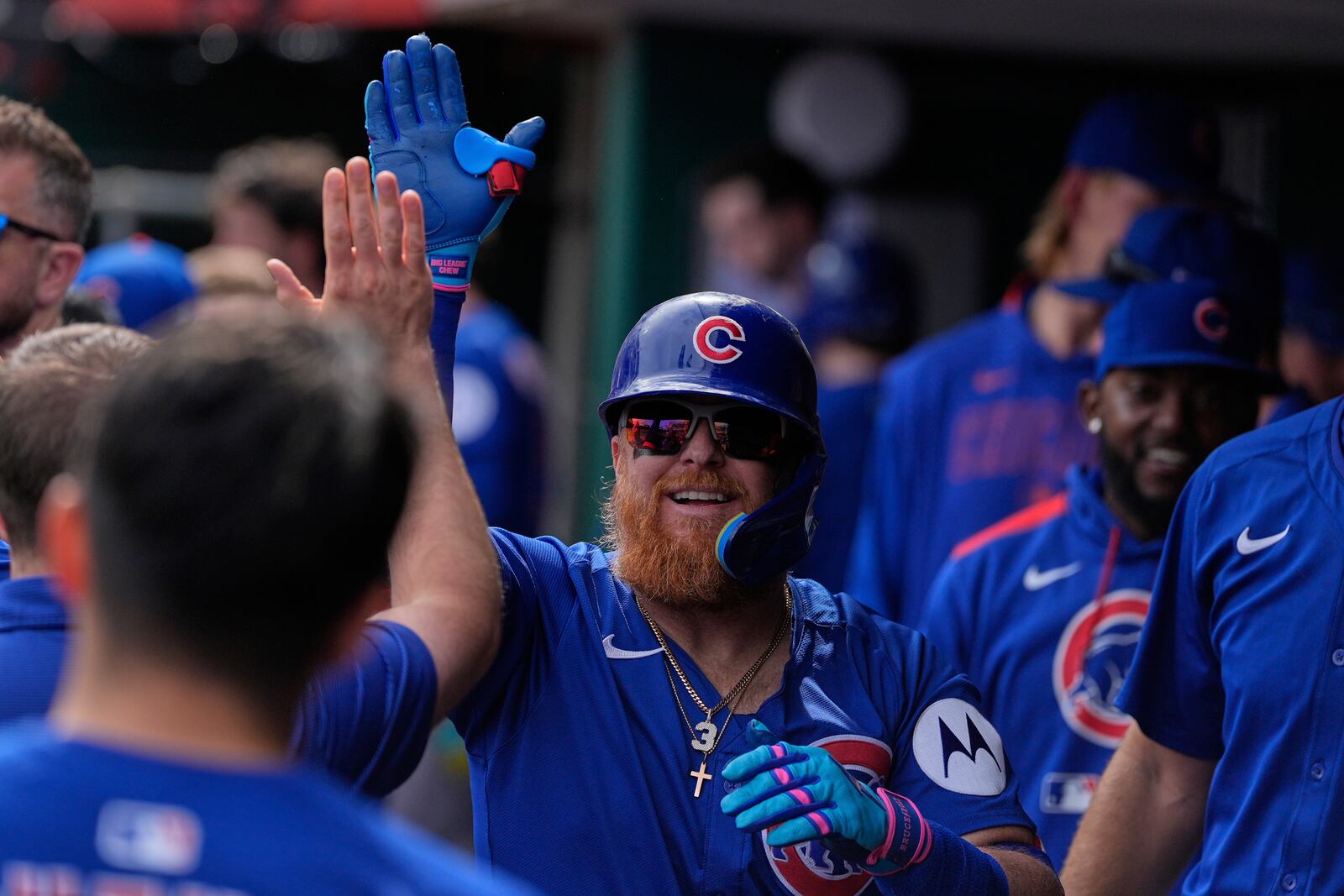 Chicago Cubs' Justin Turner celebrates in the dugout after hitting a home run in the third inning of a baseball game against the Cincinnati Reds, Saturday, May 24, 2025, in Cincinnati. (AP Photo/Carolyn Kaster)