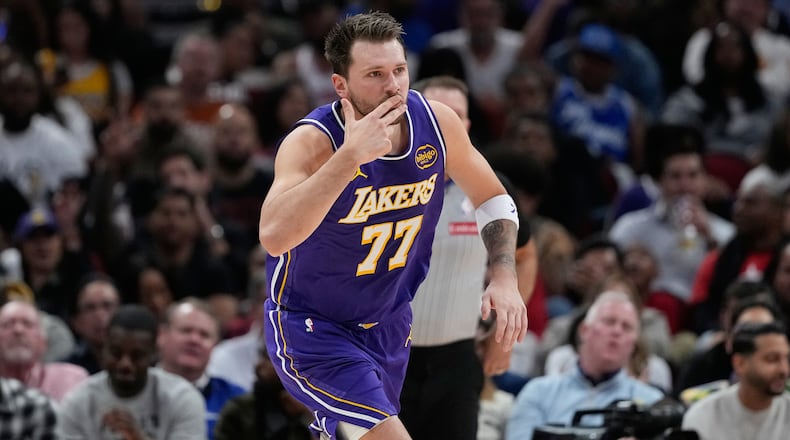 Los Angeles Lakers' Luka Doncic celebrates after making a 3-pointer against the Houston Rockets during the first half of an NBA basketball game Wednesday, March 18, 2026, in Houston. (AP Photo/David J. Phillip)