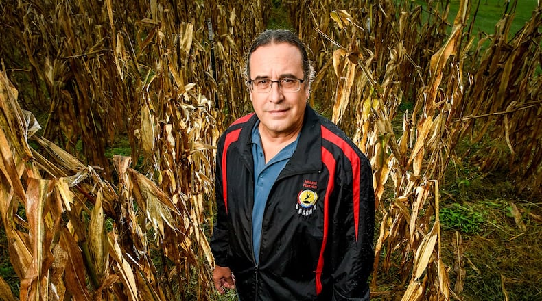 Daryl Baldwin, a citizen of the Miami Tribe of Oklahoma and Director of the Myaamia Center at Miami University, stands last fall in a patch of tribal corn raised from preserved seeds on university’s ecology center farm off campus. Baldwin, who has spent decades studying, preserving and sharing the language and culture of the Native American Miami Tribe, was the first Southwest Ohio winner of the national MacArthur Foundation genius grant. NICK GRAHAM/STAFF FILE 2016