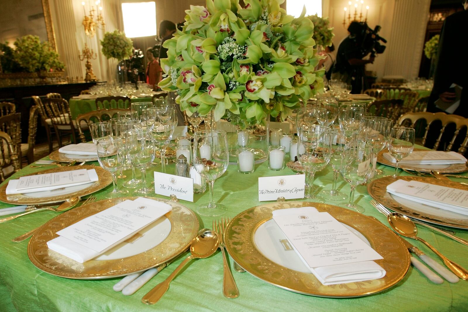 FILE - Gold china commissioned under the President Bill Clinton administration to commemorate the 200th anniversary of the White House, is seen with place settings for President George W. Bush, left, and Japanese Prime Minister Junichiro Koizumi, right, before official dinner in the State Dining Room of the White House, June 29, 2006, in Washington. (AP Photo/Pablo Martinez Monsivais, File)