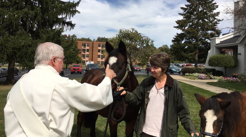 Two horses were among the animals, including humans, who received blessings at Human Family Church in Middletown on Sunday. The Rev. John Lyons, a deacon, performed the ceremony. MIKE RUTLEDGE/STAFF