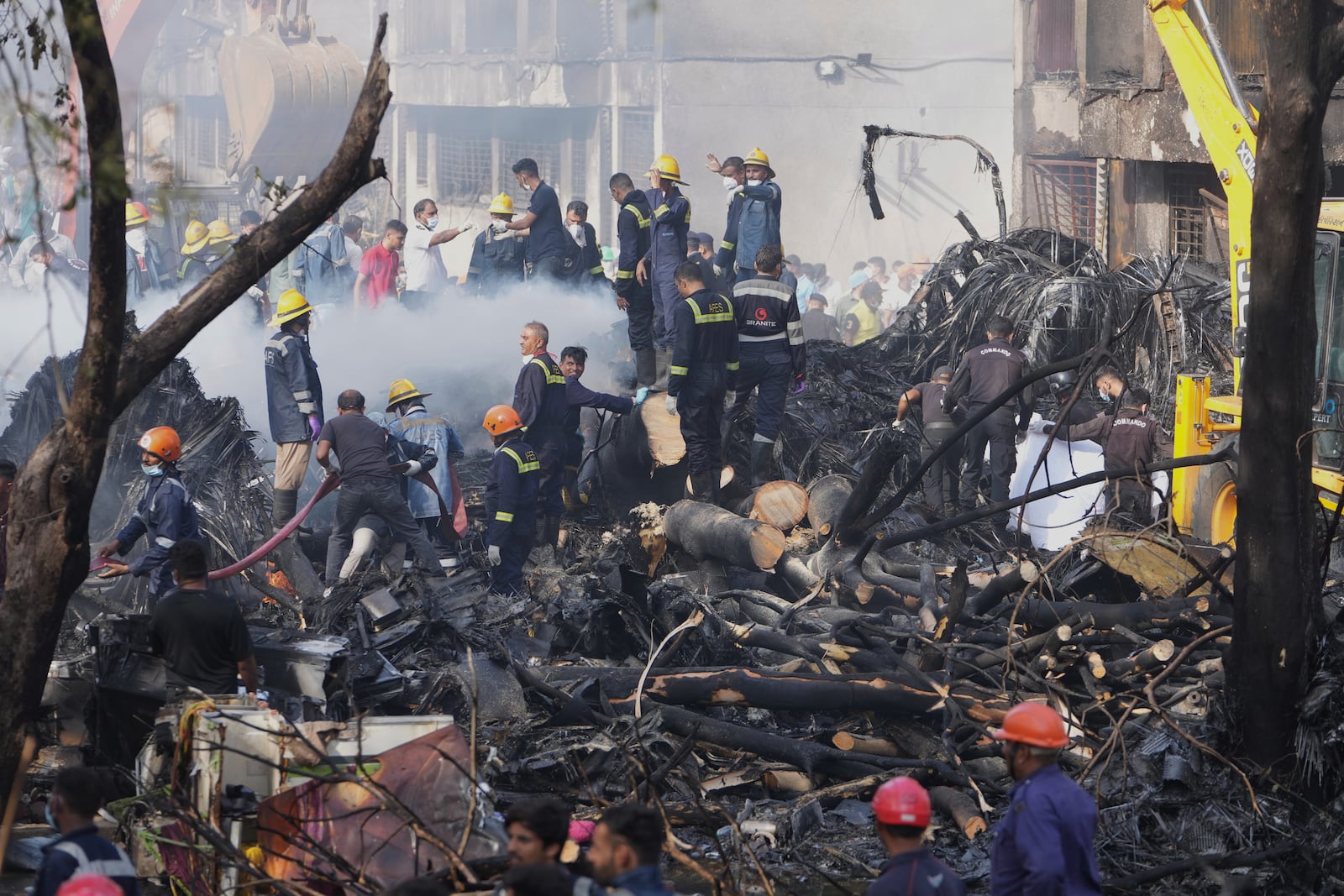 Search and rescue teams respond to the scene of a plane crash in Ahmedabad, India, Thursday, June 12, 2025. (AP Photo/Ajit Solanki)