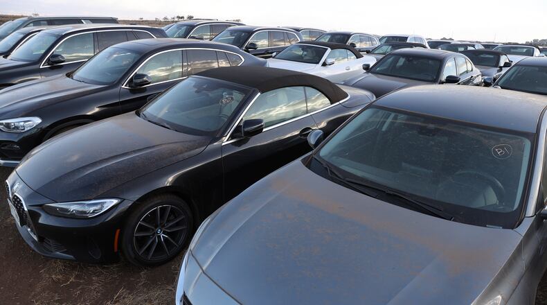 Unused rental cars fill a dusty field near Kahului Airport, Friday, Sept. 1, 2023, in Kahului, Hawaii. So few tourists are coming to the Hawaiian island of Maui after last month's wildfires that restaurants and tour companies are laying off workers and unemployment is surging. State tourism officials initially urged travelers to stay away but now want them to come back so long as they refrain from going to the burn zone and surrounding area. (AP Photo/Marco Garcia)