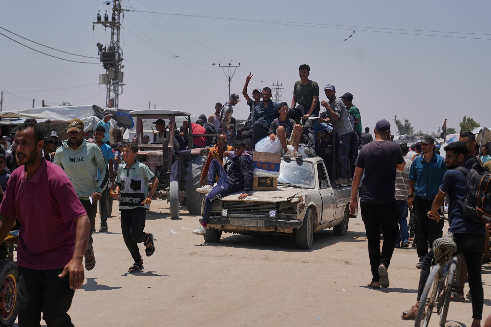 Palestinians carry food and humanitarian aid packages delivered by the Gaza Humanitarian Foundation, a U.S.-backed organization, in Rafah, southern Gaza Strip, Tuesday, June 10, 2025. (AP Photo/Abdel Kareem Hana)