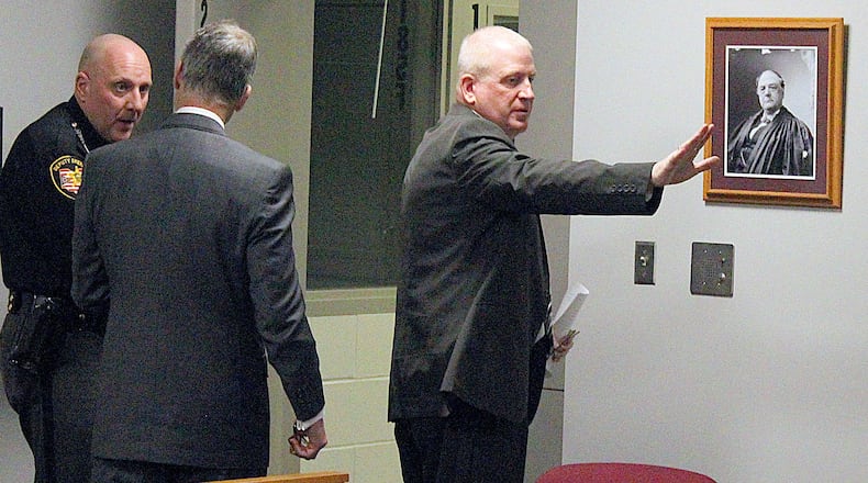 Former Indian Lake superintendent (right) Patrick O’Donnell waves good-bye to family and friends as he leaves a Logan County courtroom after being sentenced to four and one half years in prison during a sentencing hearing. JEFF GUERINI/STAFF