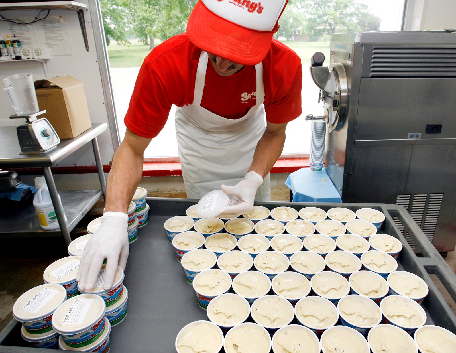 Preparing pints of peanut butter cup ice cream for sale at Young’s dairy. STAFF FILE PHOTO
