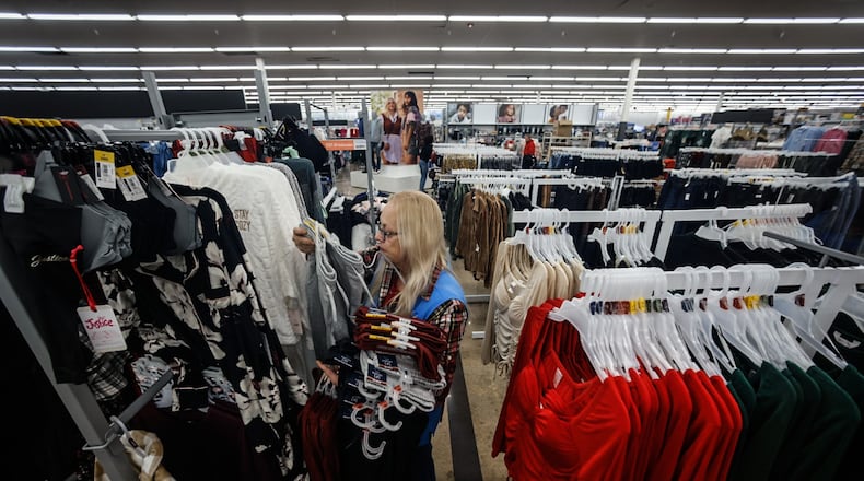 Angie Furlong restocks clothing at the Beavercreek Walmart Monday November 14, 2022. The Beavercreek Walmart is upgrading its store making it easier to find what customers are looking for, as well as enhanced digital displays to provide more information and also link shoppers to its website for more products. JIM NOELKER/STAFF