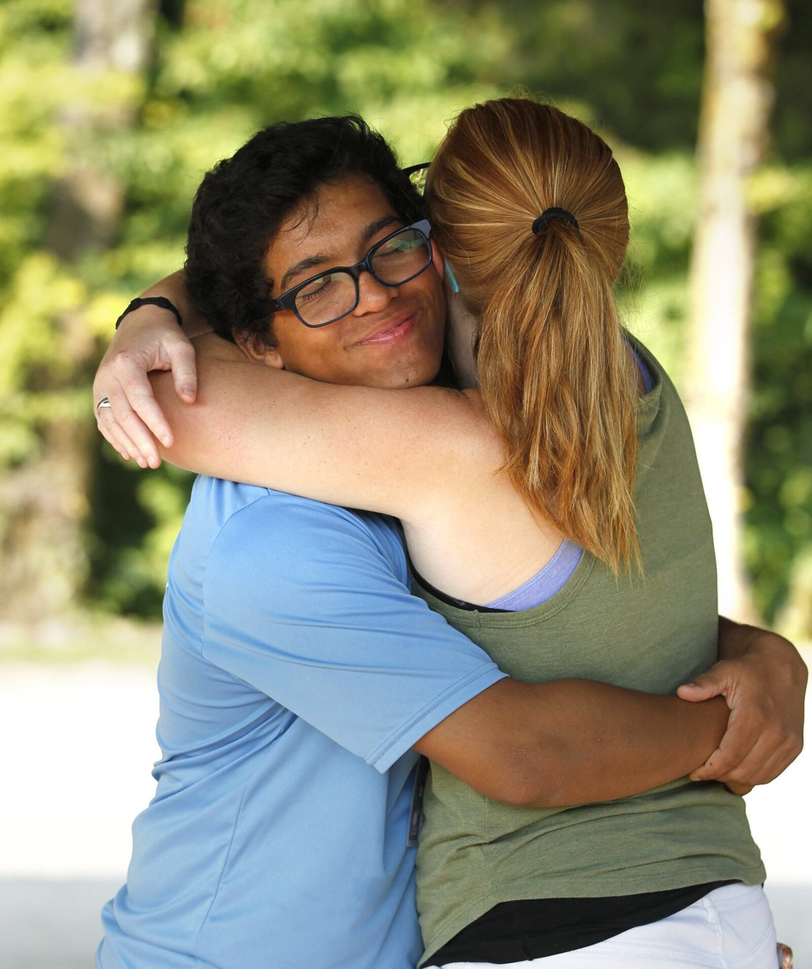 Christian gets a hug from Camp Sunrise counselor Summer Gragg. TY GREENLEES / STAFF