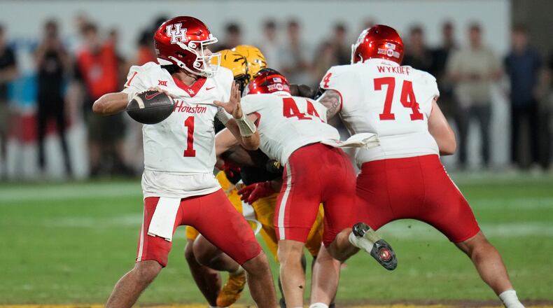 Houston quarterback Conner Weigman (1) throws against Arizona State during the second half of an NCAA college football game Saturday, Oct. 25, 2025, in Tempe, Ariz. (AP Photo/Ross D. Franklin)