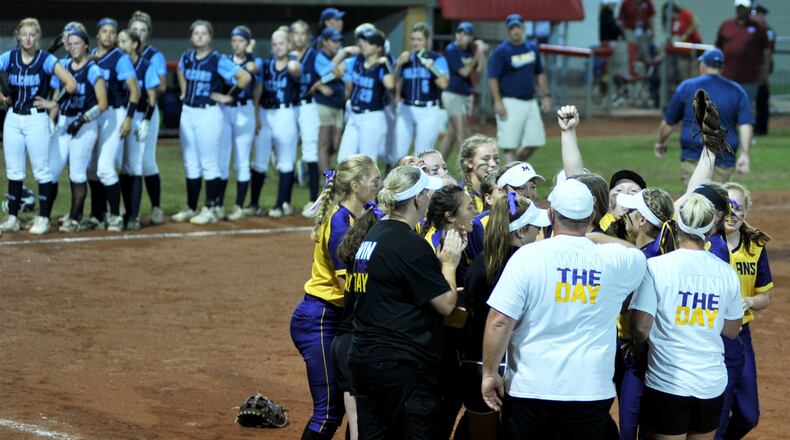 The Mechanicsburg players and coaches celebrate Friday night after defeating Jeromesville Hillsdale 7-3 in a Division IV state softball semifinal at Firestone Stadium in Akron. RICK CASSANO/STAFF