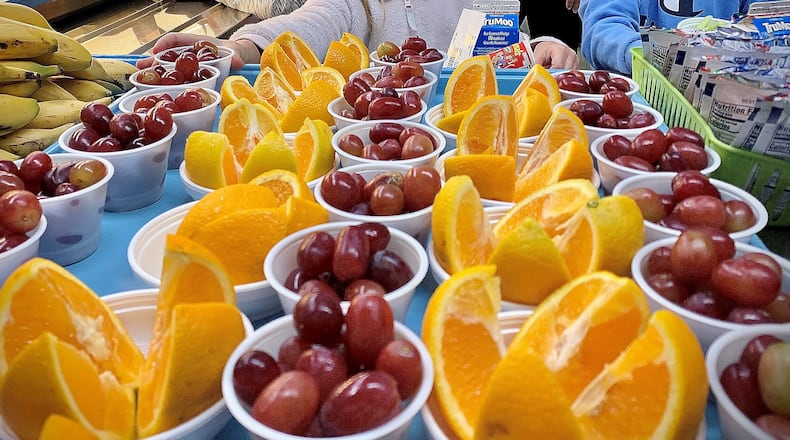 Fruit for school lunches are arranged for students on Tuesday Sept. 13, 2022 at Indian Riffle Elementary School in Kettering. MARSHALL GORBY\STAFF