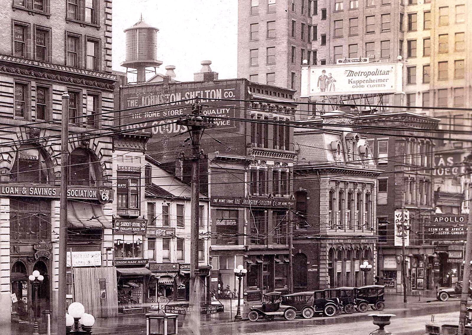 Automobiles are frozen in time parked along Main Street in front of signs for United Cigars, union made hats, Zonars Confectionary and the Metropolitan, a downtown clothing store. DAYTON METRO LIBRARY / LUTZENBERGER PICTURE COLLECTION