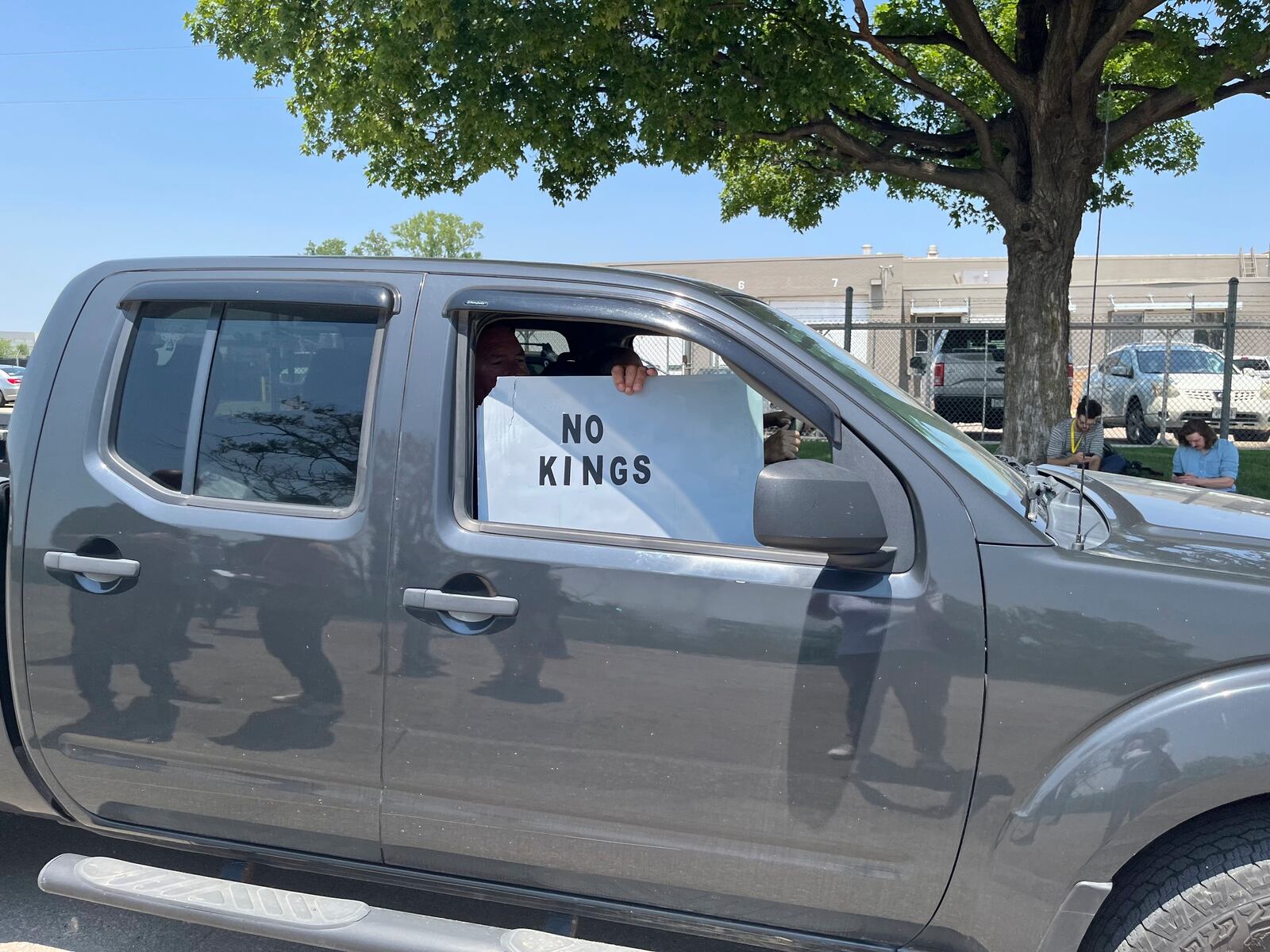A person holds a sign outside of Glenn Valley Foods, a meat packaging company that was raided by U.S. Immigration and Customs Enforcement on Tuesday, June 10, 2025, in Omaha, Neb. (AP Photo/Margery A. Beck)