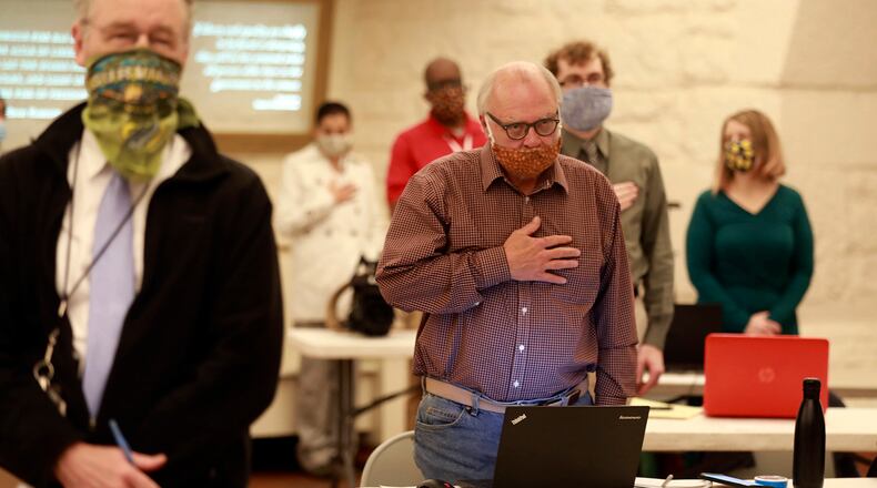 Ohio Gov. Mike DeWine played a University of Dayton choral version of the national anthem before the coronavirus news conference at the Statehouse Thursday, May 21, 2020, because of the upcoming Memorial Day holiday. (Doral Chenoweth/The Columbus Dispatch via AP)