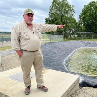 Terry Bauer, construction quality control manager for Weston Solutions working on Wright-Patterson Air Force Base, near a water basin on the base's Area A, not far from the Mad River. THOMAS GNAU/STAFF