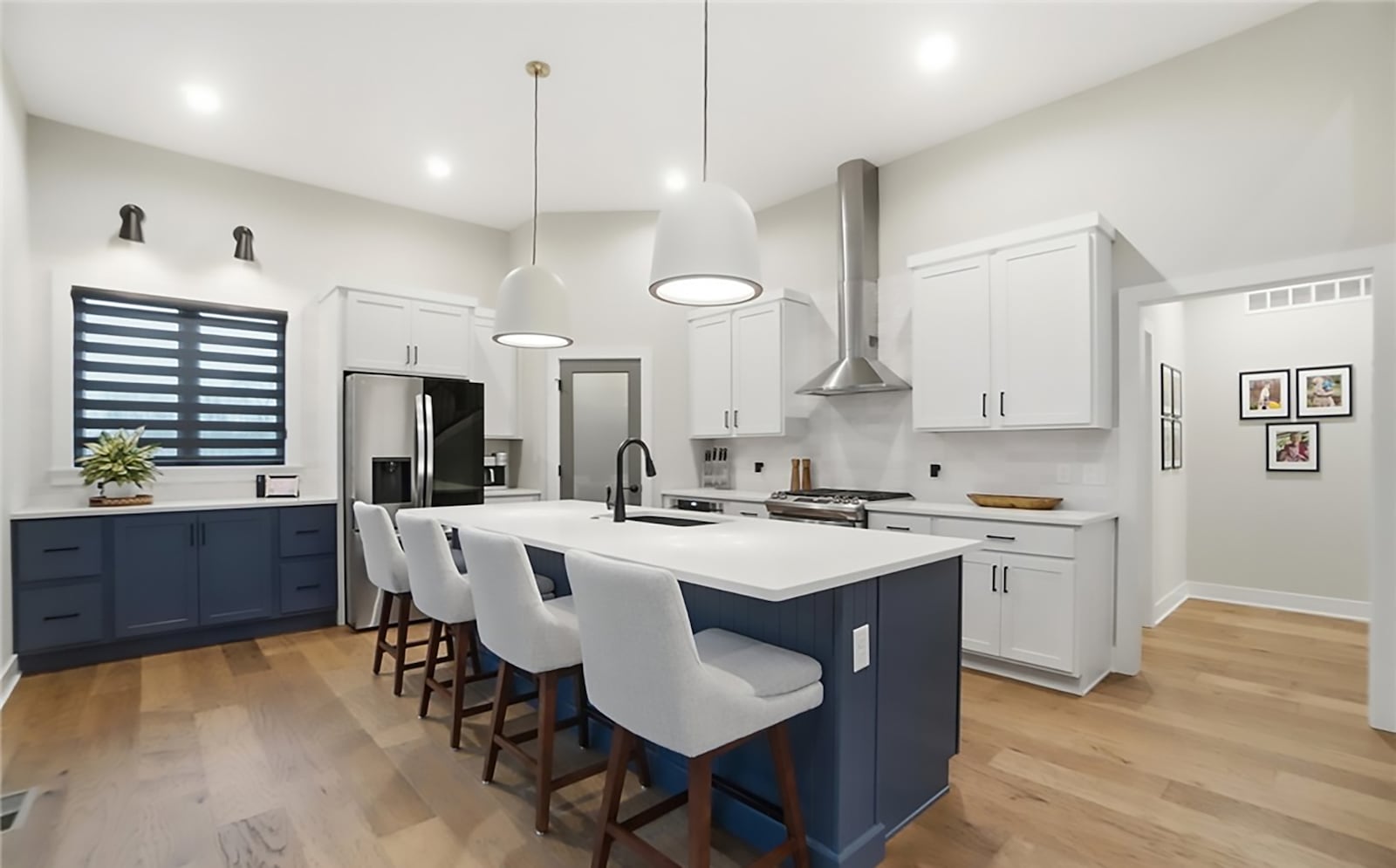 The gourmet style kitchen has hardwood floors, an island with a breakfast bar and professional style appliances. CONTRIBUTED