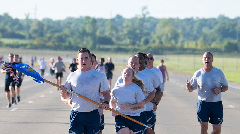 Master Sgt. Sean Loveland (with guidon), 88th Security Forces Squadron first sergeant, leads Airmen in the Run for the Fallen on Sept. 9 at Wright-Patterson Air Force Base. They were among more than 500 Wright-Patt community members who came out to mark the 21st anniversary of the Sept. 11 attacks and remember victims, including the first responders killed as the twin towers collapsed. U.S. AIR FORCE PHOTO/R.J. ORIEZ