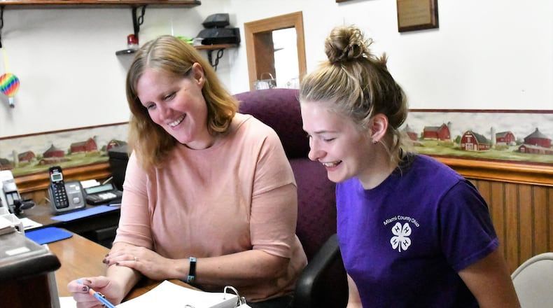 Jill Wright, secretary/manager of the Miami County Fair, at left, talks with Kelci Cooper, a 4-H member and Junior Fair Board member about preparations for the 2018 fair that runs Aug. 10-16 at the fairgrounds just north of Troy. CONTRIBUTED