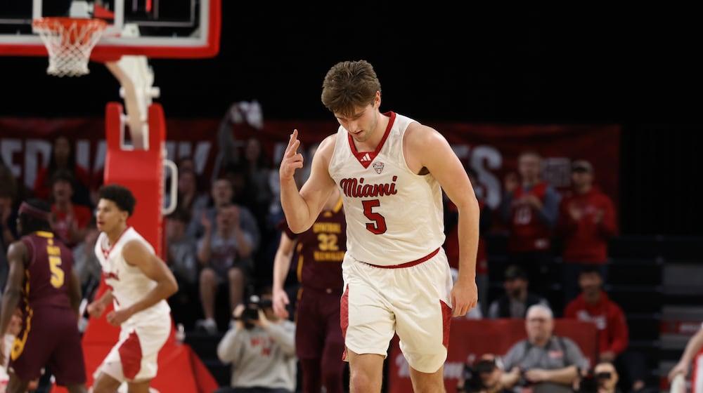 Miami’s Peter Suder celebrates after sinking a 3-pointer against Central Michigan on Tuesday night at Millett Hall. ELIJAH COOK / CONTRIBUTED