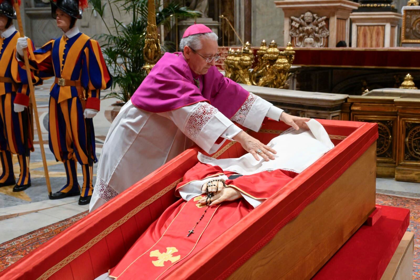 Vatican Master of Ceremonies Archbishop Diego Giovanni Ravelli covers the face of late Pope Francis with a silk cloth before closing his casket in St. Peter's Basilica at the Vatican Friday, April 25, 2025. (Vatican Media via AP)