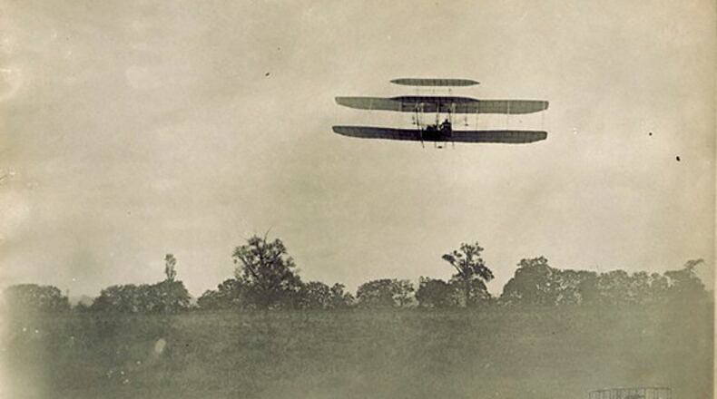 Right front view of Orville Wright piloting the Wright 1905 Flyer during the 23rd flight at Huffman Prairie. The Flyer completed two circles of the field in 2 mins, 45 secs.