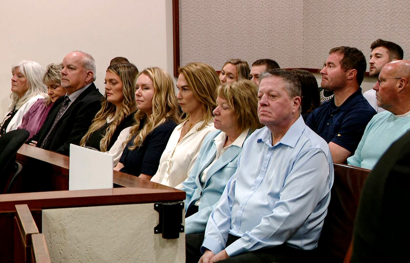 This video image provided by WOOD-TV shows Christopher Schurr family members and supporters sitting in court at the Kent County Courthouse in Grand Rapids, Mich. on the first day of his trial on Monday, April 28, 2025. (WOOD-TV via AP, Pool)
