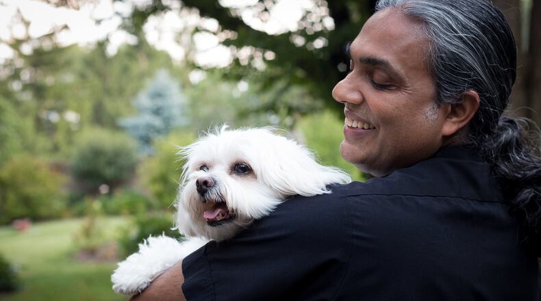 The Rev. Satish Joseph and his pet dog, Tutu. CONTRIBUTED