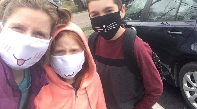 Many Ohioans in the last week have received notice that they are to start working remotely, and that schools will be out of session for weeks in light of the coronavirus pandemic, and that means a self-quarantine at home. Jenny Schumacher, her daughter Cady and son, Josiah, show the sign of the times as they get outside to get some fresh air.