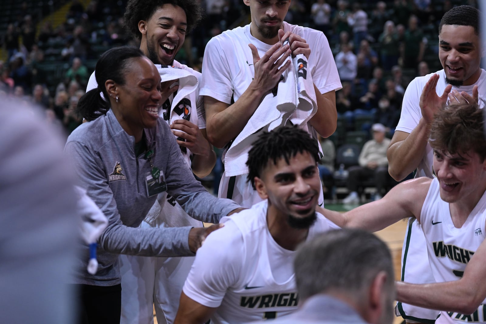 Wright State men's basketball athletic trainer LaShaunta' Jones (left) celebrates with former Raiders player Trey Calvin after he scored his 1,000th point against Robert Morris on Feb. 9, 2024. JOSEPH R. CRAVEN / CONTRIBUTED PHOTO