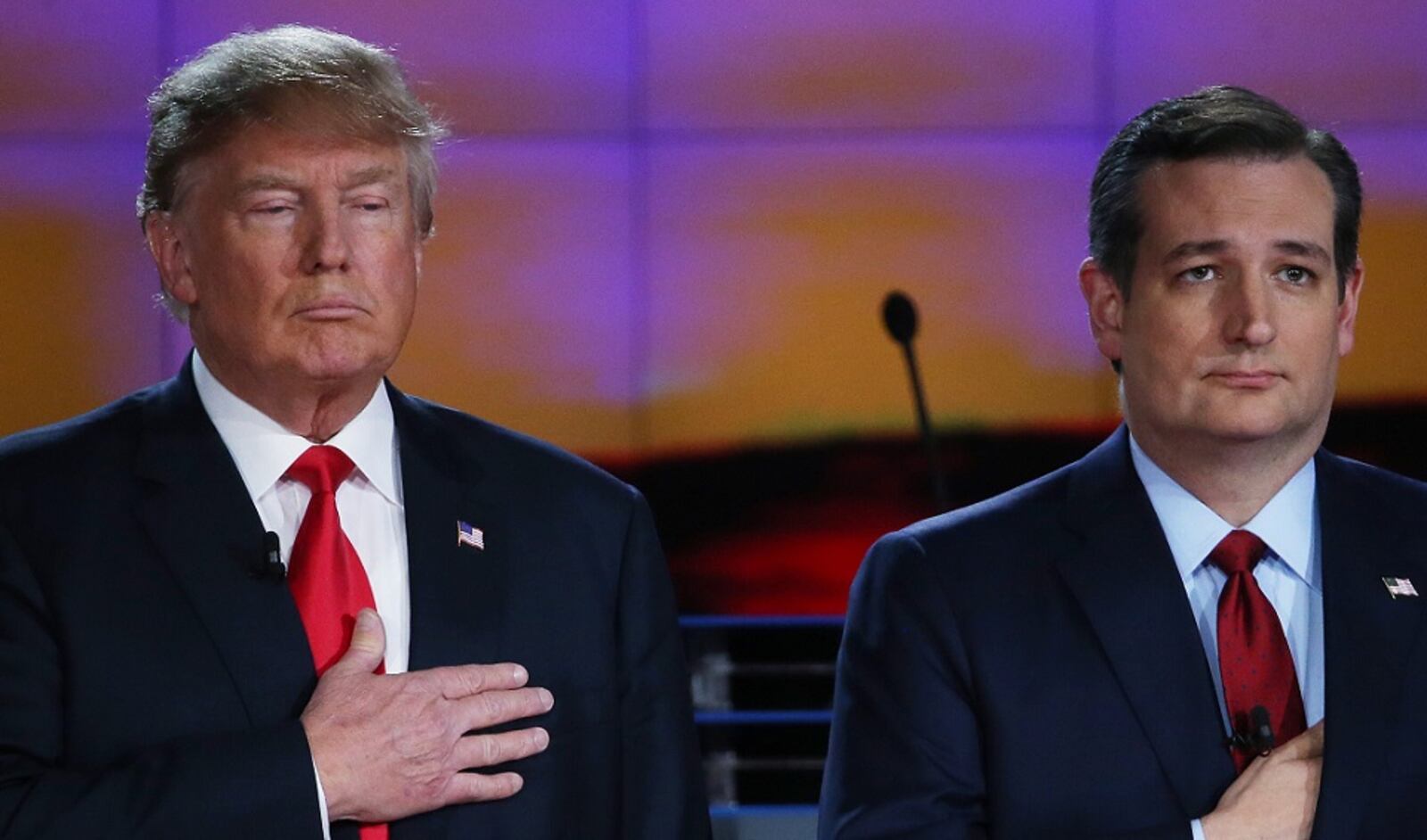LAS VEGAS, NV - DECEMBER 15: Republican presidential candidates Donald Trump (L) and U.S. Sen. Ted Cruz (R-TX) hold their hands over their hearts during the National Anthem during the CNN Republican presidential debate on December 15, 2015 in Las Vegas, Nevada. This is the last GOP debate of the year, with U.S. Sen. Ted Cruz (R-TX) gaining in the polls in Iowa and other early voting states and Donald Trump rising in national polls. (Photo by Justin Sullivan/Getty Images)