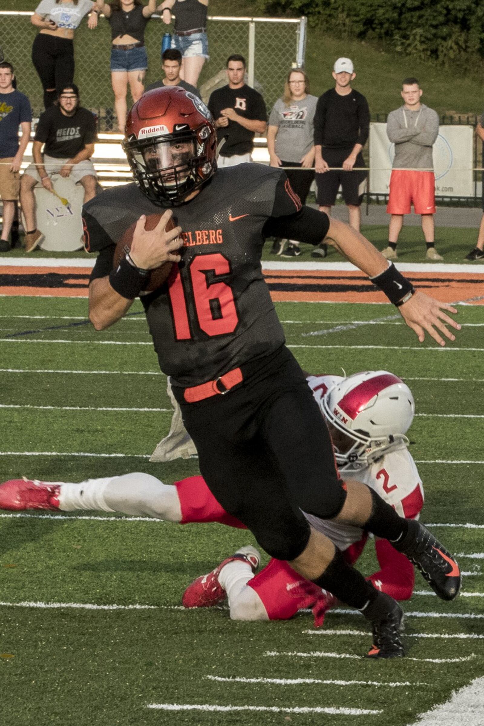 Heidelberg quarterback Trace Reynolds runs past John Adams III of Olivet (Mich.) during a Sept. 1 game at Hoernemann Stadium in Tiffin. Reynolds led the Student Princes to a season-opening 21-17 victory. DOUG SAMPSON/HEIDELBERG ATHLETICS