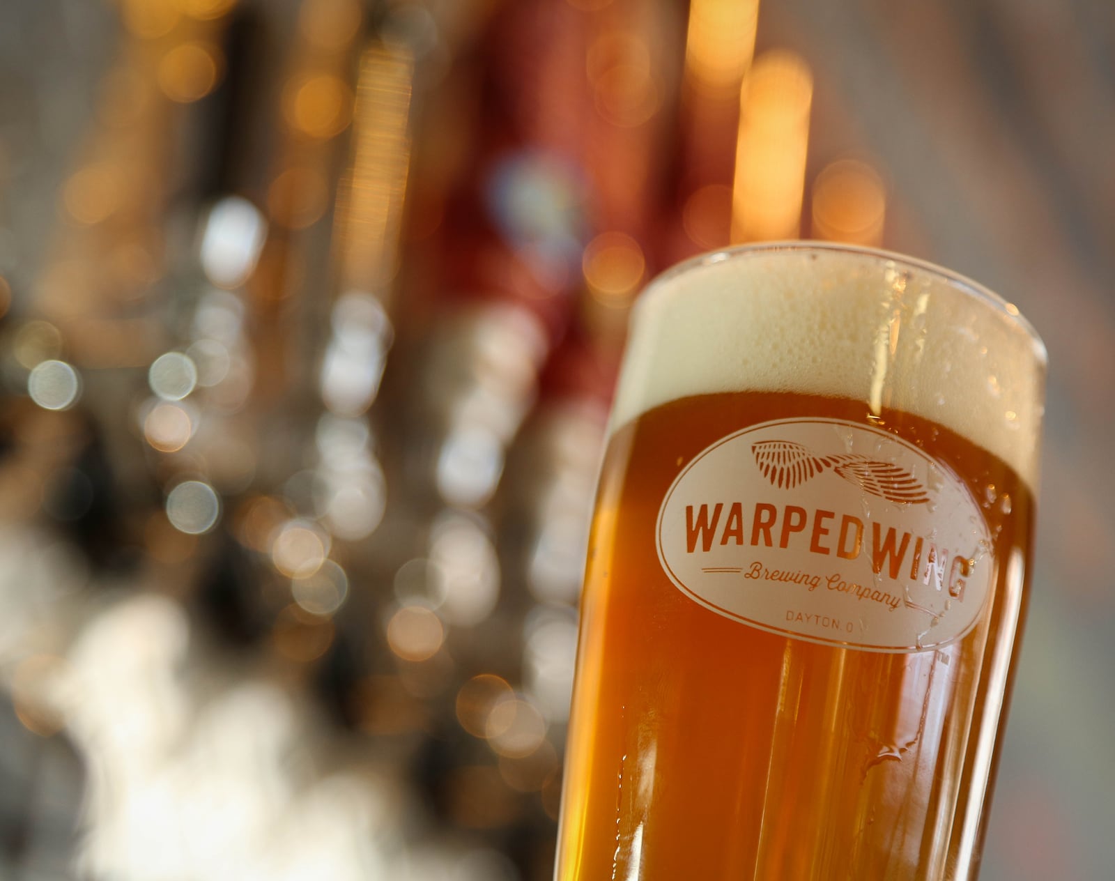 "Hop Smuggler" on the bar of the tasting room at Warped Wing Brewing Company production facility at  26 Wyandot Street, Dayton. JIM WITMER / STAFF