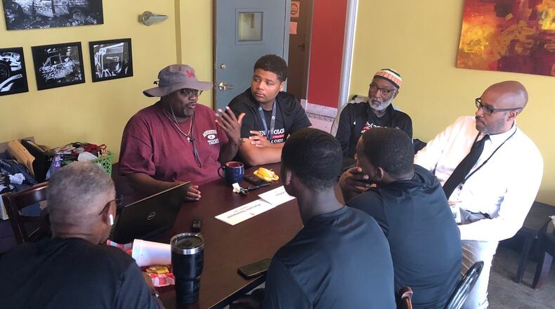 Community activist Marlon Shackelford talks to students and school and city leaders July 30 at the Third Perk Coffeehouse & Wine Bar downtown, discussing efforts to help more young black students succeed in life. JEREMY P. KELLEY / STAFF