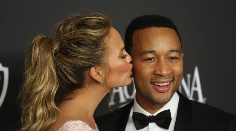 Chrissy Teigen, left, and John Legend arrive at the 16th annual InStyle and Warner Bros. Golden Globes afterparty at the Beverly Hilton Hotel on Sunday, Jan. 11, 2015, in Beverly Hills, Calif. (Photo by Matt Sayles/Invision/AP) Chrissy Teigen, left, and John Legend arrive at the 16th annual InStyle and Warner Bros. Golden Globes afterparty at the Beverly Hilton Hotel on Sunday, Jan. 11, 2015, in Beverly Hills, Calif. (Photo by Matt Sayles/Invision/AP)