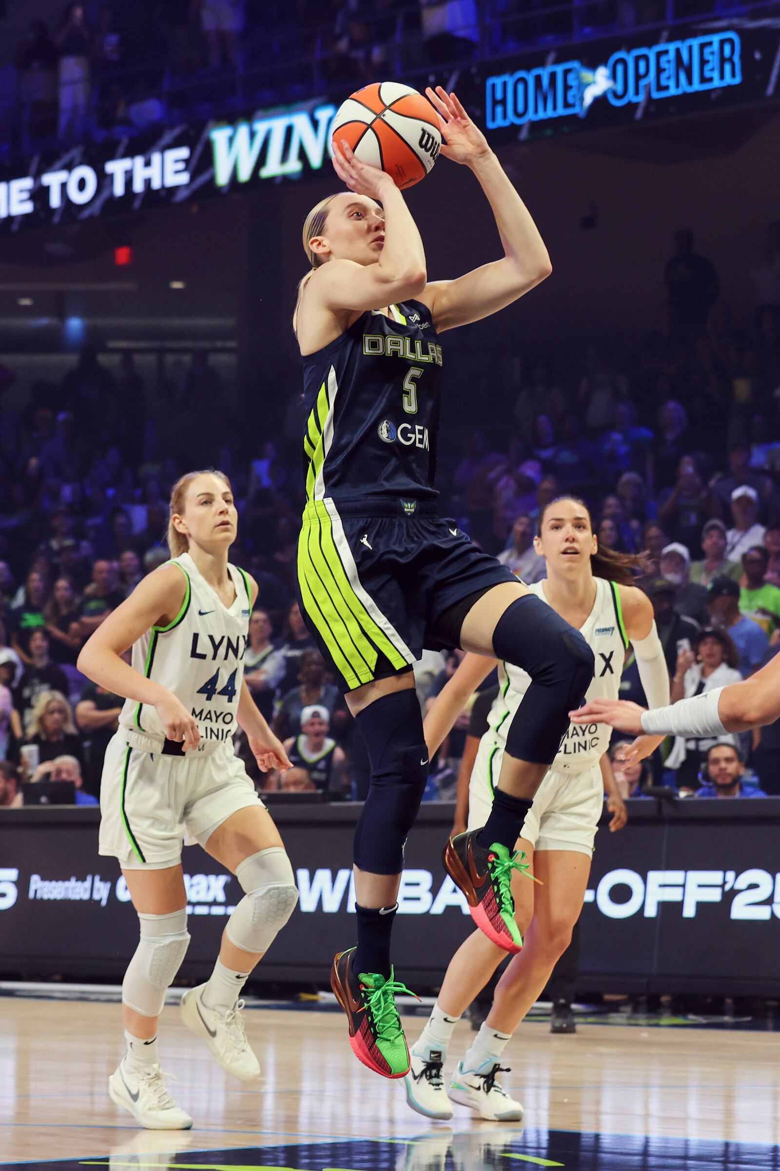 Dallas Wings guard Paige Bueckers (5) shoots after getting past Minnesota Lynx's Karlie Samuelson (44) in the first half of a WNBA basketball game Friday, May 16, 2025, in Arlington, Texas. (AP Photo/Richard Rodriguez)