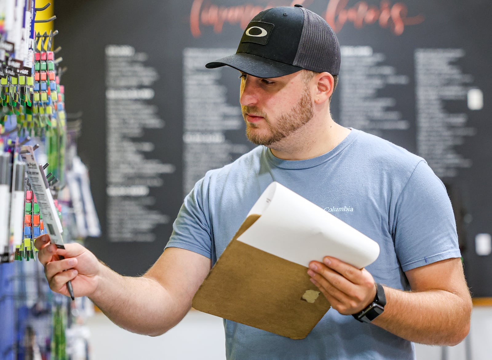 Grant Gariety, a first-year teacher at Bellefontaine Middle School, looks at paint while shopping at Crayons to Classrooms on Wednesday, July 30. BRYANT BILLING / STAFF