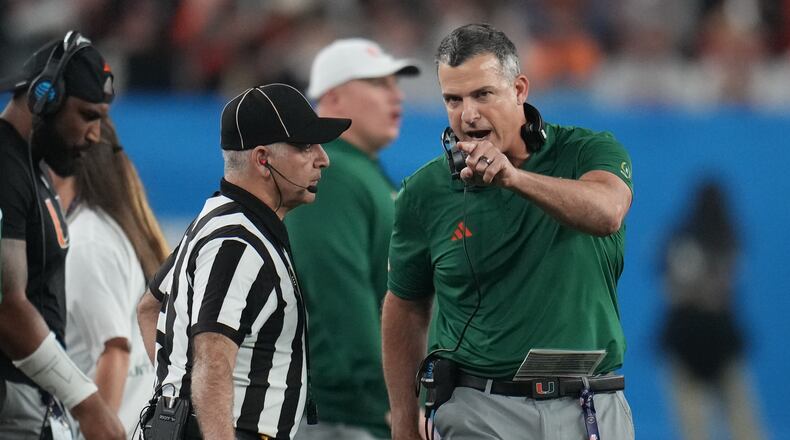 Miami head coach Mario Cristobal yells from the sideline during the second half of the Fiesta Bowl NCAA college football playoff semifinal game against Mississippi, Thursday, Jan. 8, 2026, in Glendale, Ariz. (AP Photo/Rick Scuteri)