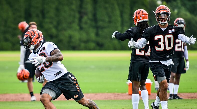 Bengals’ running back Joe Mixon carries the ball as safety Jessie Bates (30) stands in the background during organized team activities Tuesday, May 22 at the practice facility near Paul Brown Stadium in Cincinnati. NICK GRAHAM/STAFF