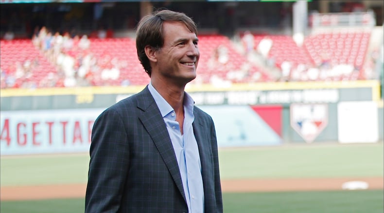 CINCINNATI, OH - JUNE 16: Scooter Gennett #4 of the Cincinnati Reds waves to fans while standing with general manager Dick Williams during a ceremony to commemorate his four home run game from June 6 prior to a game against the Los Angeles Dodgers at Great American Ball Park on June 16, 2017 in Cincinnati, Ohio. (Photo by Joe Robbins/Getty Images)