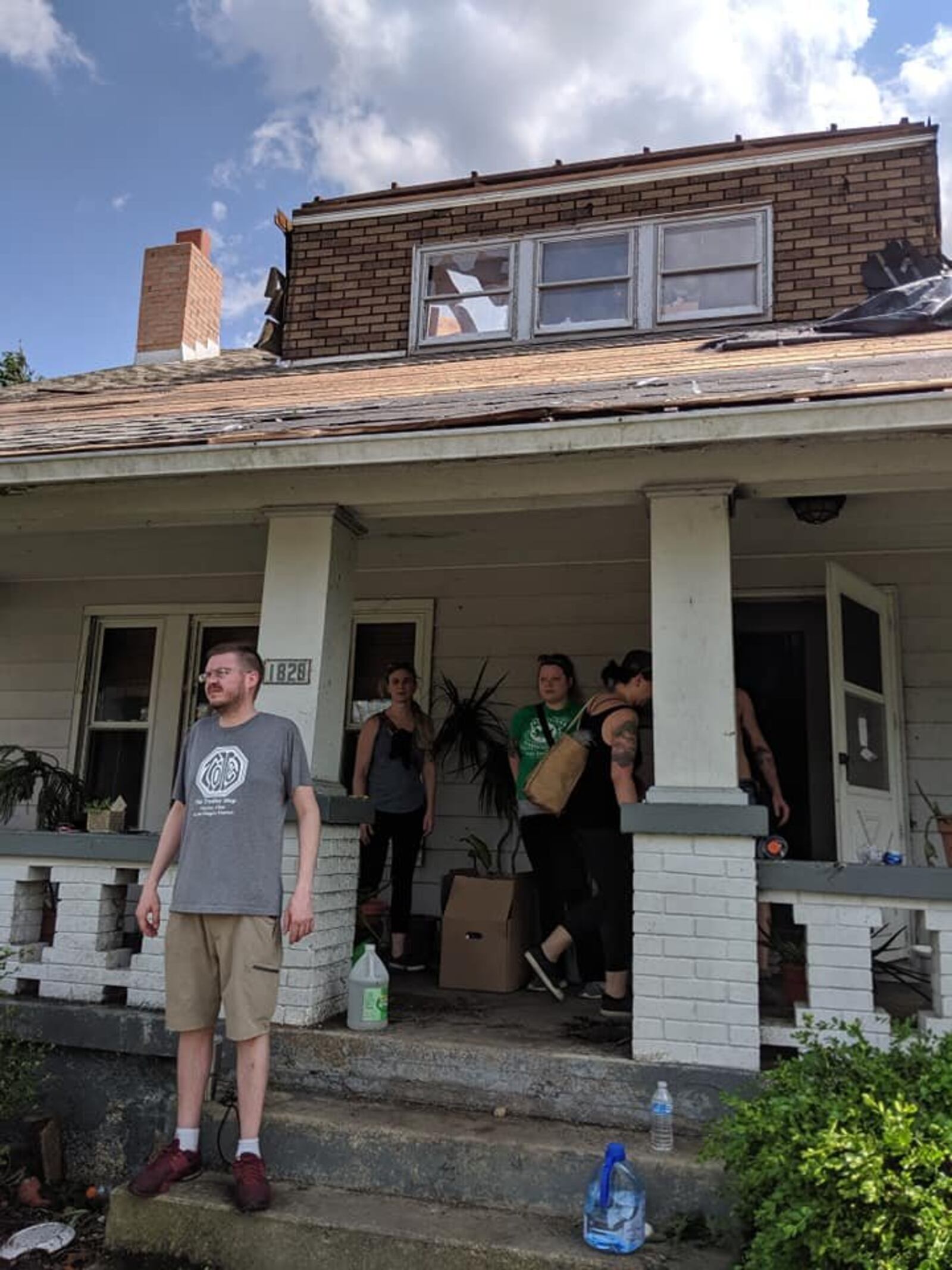 Friends and volunteers from the Oregon District worked to secure and clear Robin and Chris Sassenberg's Hillsdale Avenue home of debris the day following the Memorial Day tornadoes.