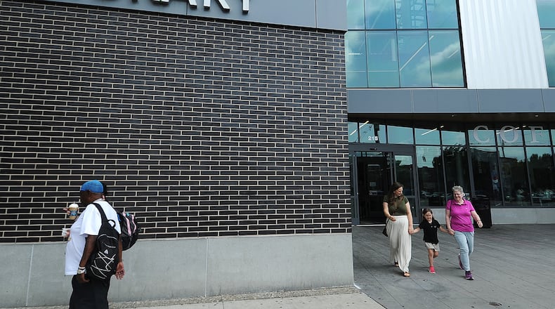 Lots of visitors coming and going Wednesday, May 22, 2024, at Dayton Metro Library’s main branch. MARSHALL GORBY\STAFF