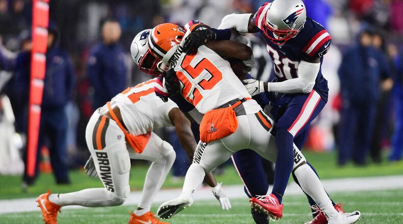 FOXBOROUGH, MASSACHUSETTS - OCTOBER 27: Running back Dontrell Hilliard #25 of the Cleveland Browns is tackled by outside linebacker Jamie Collins #58 and cornerback Jason McCourty #30 of the New England Patriots in the second quarter of the game at Gillette Stadium on October 27, 2019 in Foxborough, Massachusetts. (Photo by Billie Weiss/Getty Images)