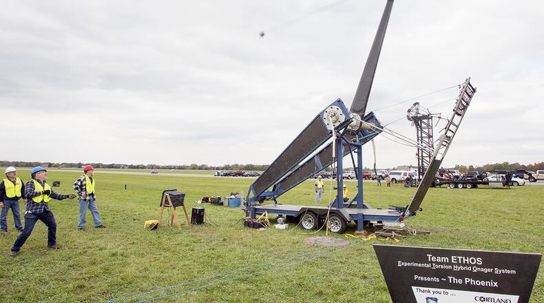 David Mollenhauer, in blue hardhat, Team ETHOS team captain, pulls the trigger of the Phoenix, launching a 10-pound pumpkin downrange at the end of the 13th annual Pumpkin Chuck, Oct. 27, 2017. The competition gave teams the opportunity to show off their engineering skills. (U.S. Air Force photo/R.J. Oriez)