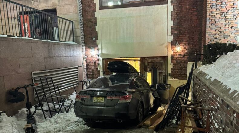 This photo provided by Rabbi Yaacov Behrman shows a car that crashed into the Chabad Lubavitch world headquarters in New York City, late Wednesday, Jan.28, 2026. (@ChabadLubavitch/UGC via AP)
