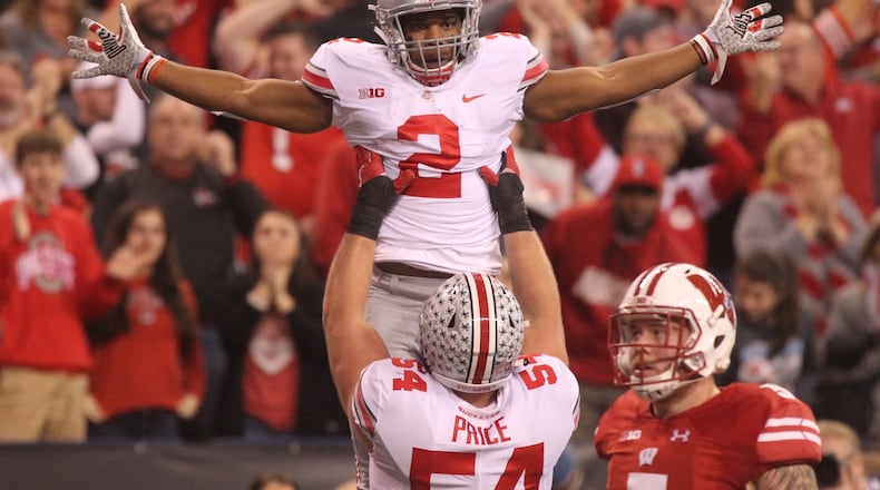 David Jablonski - Staff WriterOhio States Billy Price lifts J.K. Dobbins after a 77-yard run against Wisconsin in the Big Ten Championship on Saturday, Dec. 2, 2017, at Lucas Oil Stadium in Indianapolis, Ind. David Jablonski/Staff